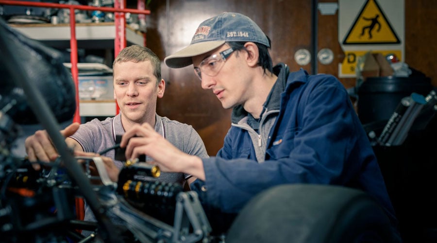 Engineering students working with machinery